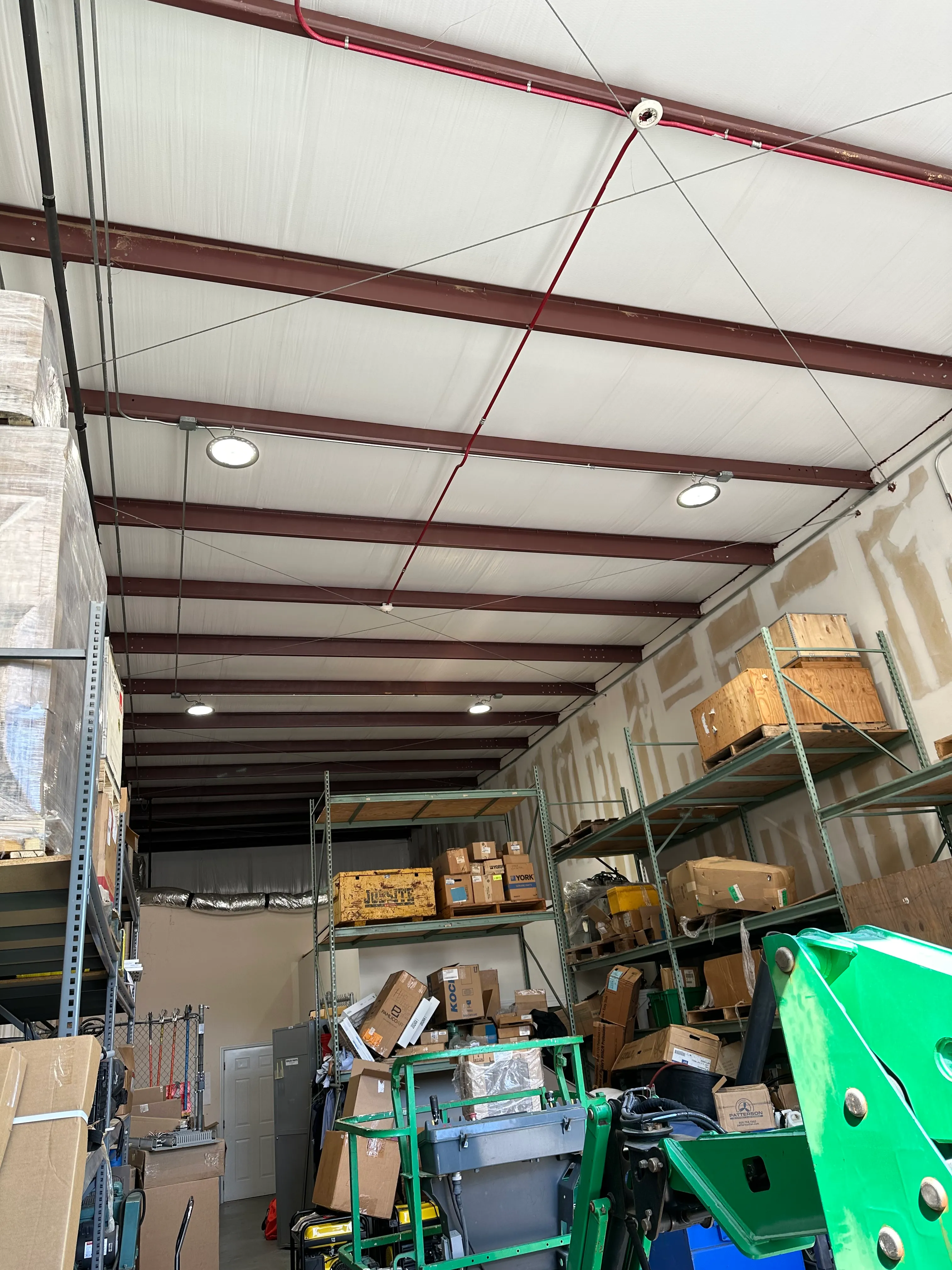 Illuminated high-bay light fixtures in a commercial storage building